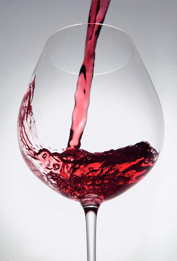 Wine Photograph - Pouring Red Wine Into A Glass by Peter Garten