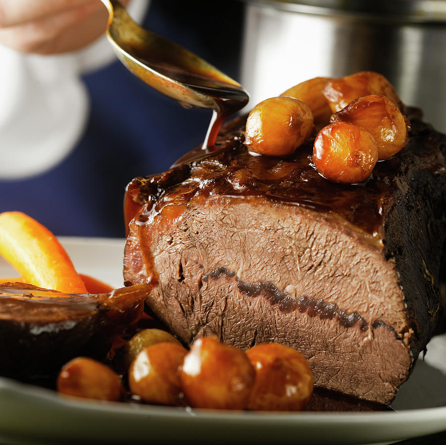 Pouring Sauce On Joint Of Braised Beef by Duncan Davis