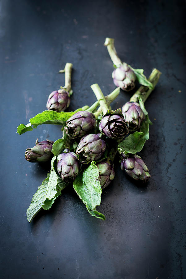 Poveraden baby Artichokes On A Dark Background Photograph by Manuela Rther