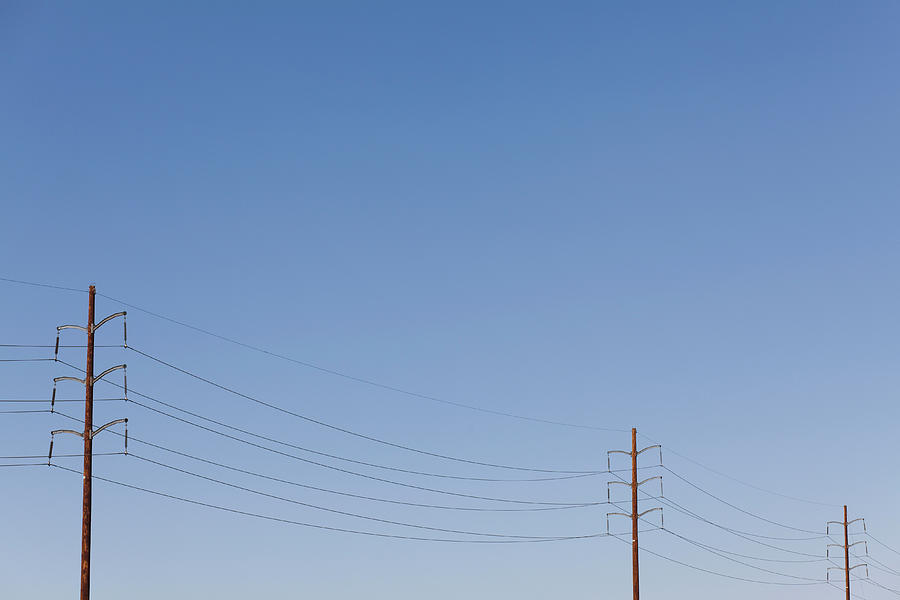 Power Lines Against A Clear Sky Photograph by Patrick Strattner