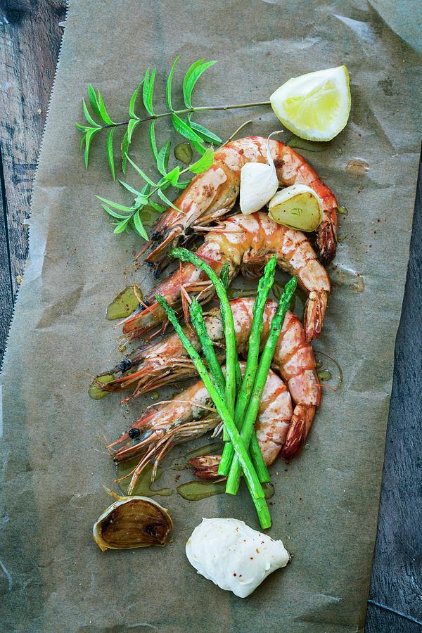 Prawns With Garlic, Asparagus And Mayonnaise On A Piece Of Baking Paper Photograph by Jan Wischnewski