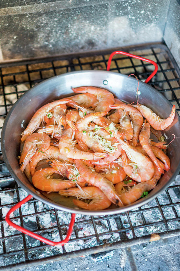 Fish Photograph - Prawns With Garlic In A Pan On A Grill by Sebastian Schollmeyer