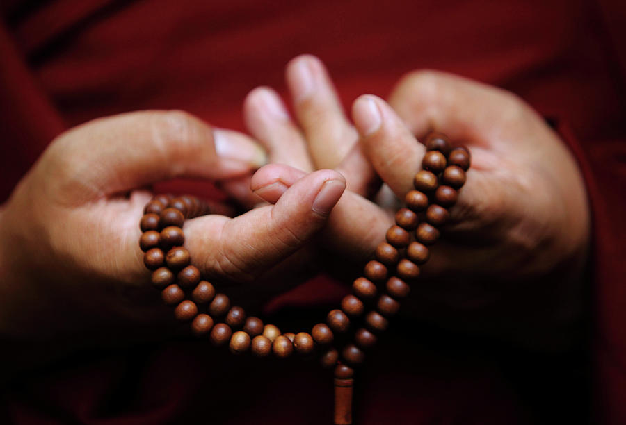 Prayer Beads Are Seen As a Tibetan Monk Photograph by Navesh Chitrakar ...