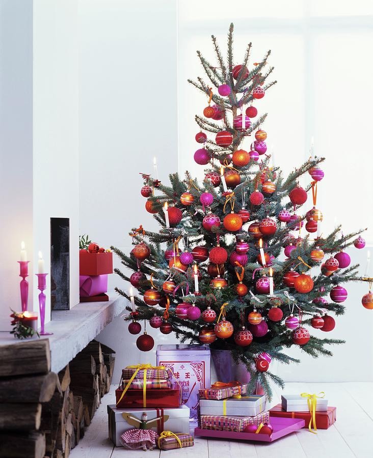 Presents Below Christmas Tree Lavishly Decorated With Pink, Red And Orange Baubles Photograph by Matteo Manduzio