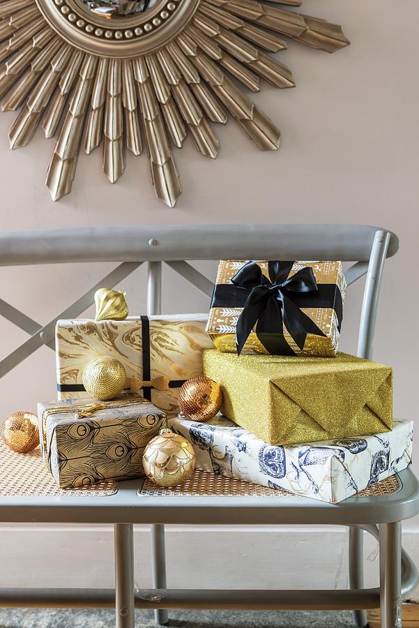 Presents Glamorously Wrapped In Gold And Blue On Wooden Bench Photograph by Winfried Heinze
