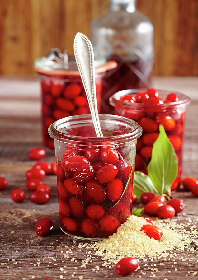 Preserved Cornelian Cherries In Almond Liqueur And Rum In Mason Jars Photograph by Teubner Foodfoto
