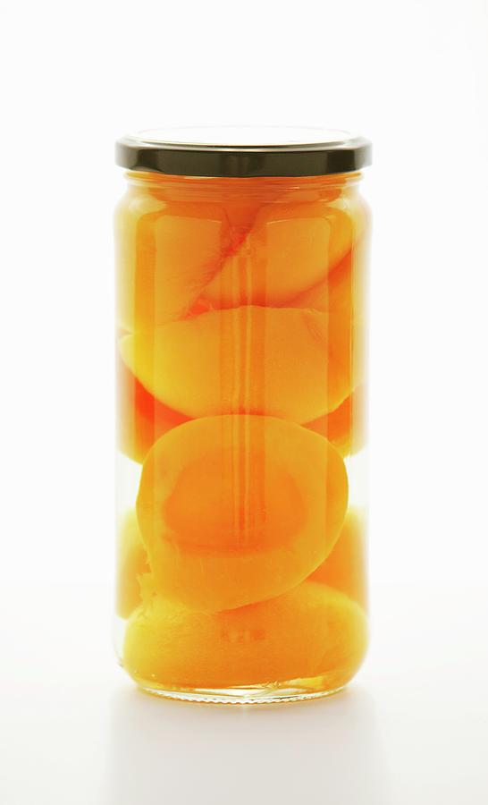 Preserved Peach Halves In A Jar Photograph by William Boch