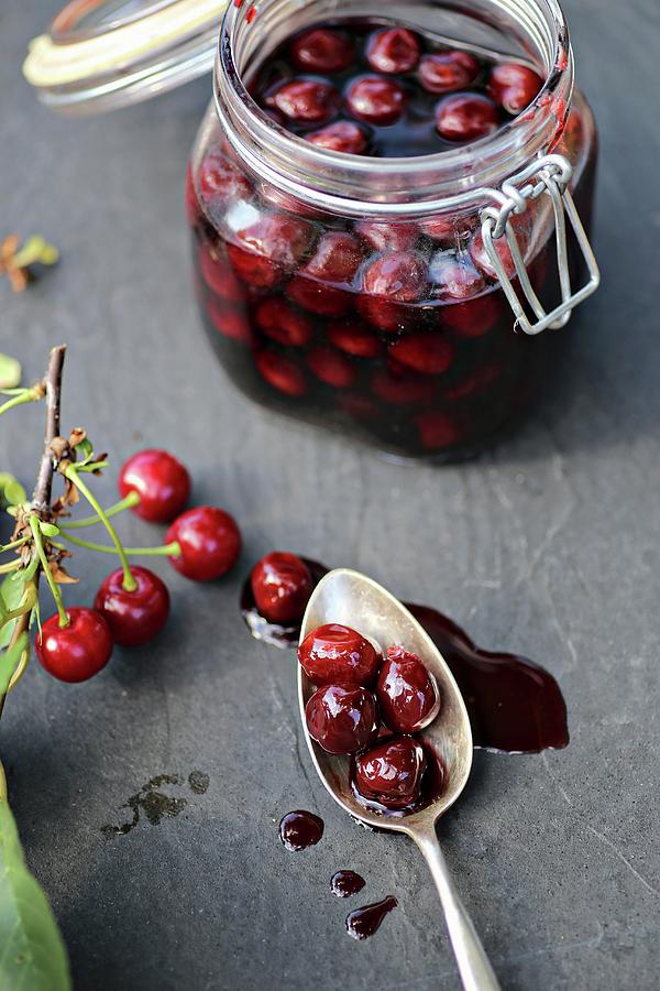 Preserved Sour Cherries On A Slate Surface Photograph by Alexandra Panella