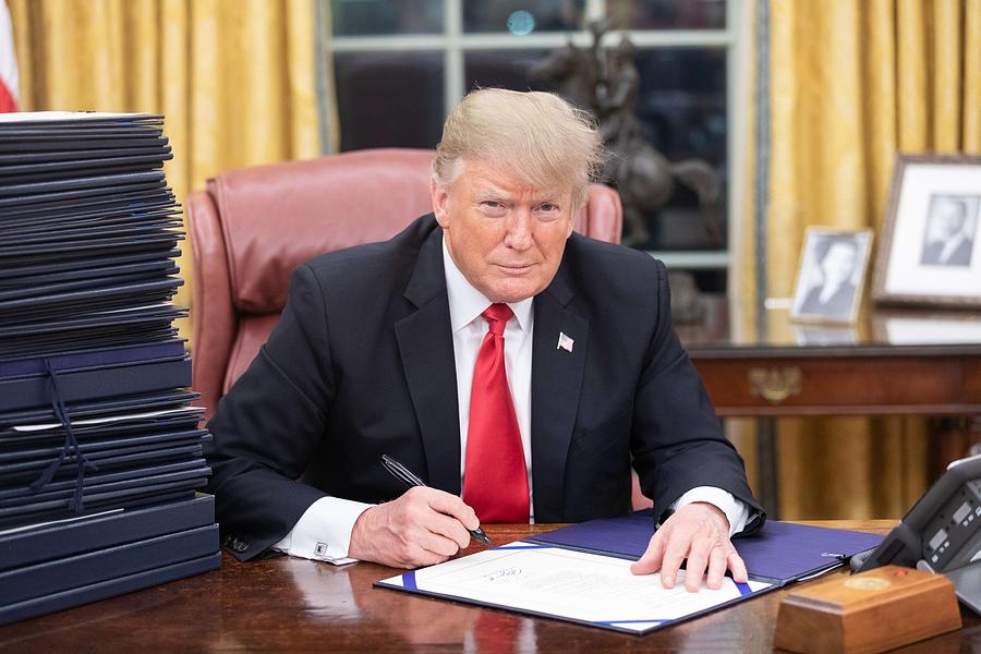 President Donald J. Trump is seen at his desk in the Oval Office with a stack of documents awaiting  Painting by Celestial Images