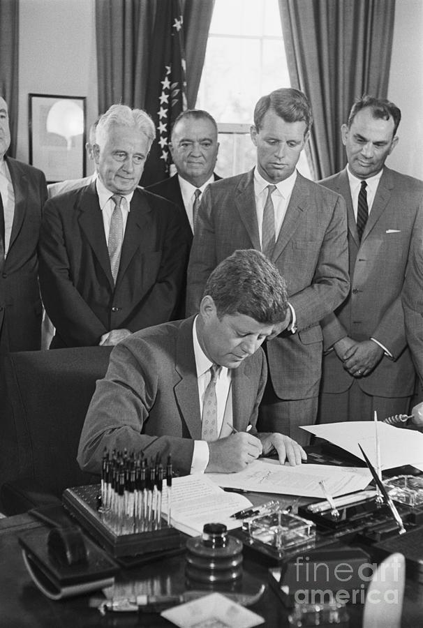 President John F. Kennedy Signs Photograph by Bettmann