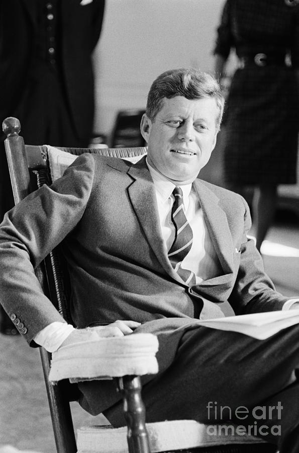 President Kennedy In Rocking Chair Photograph by Bettmann