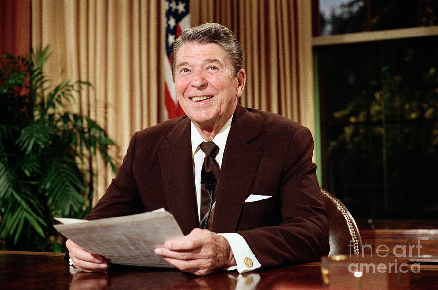 President Reagan Seated At Desk Photograph by Bettmann