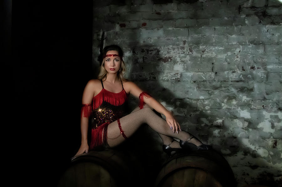Pretty lady in red on wine barrels Photograph by Dan Friend