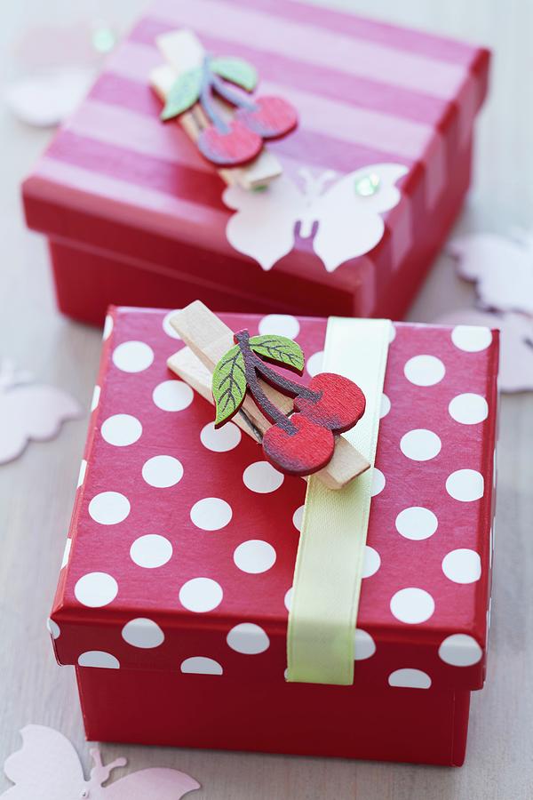 Pretty, Red And White Gift Boxes Decorated With Clothes Pegs With Cherry Motifs Photograph by Franziska Taube