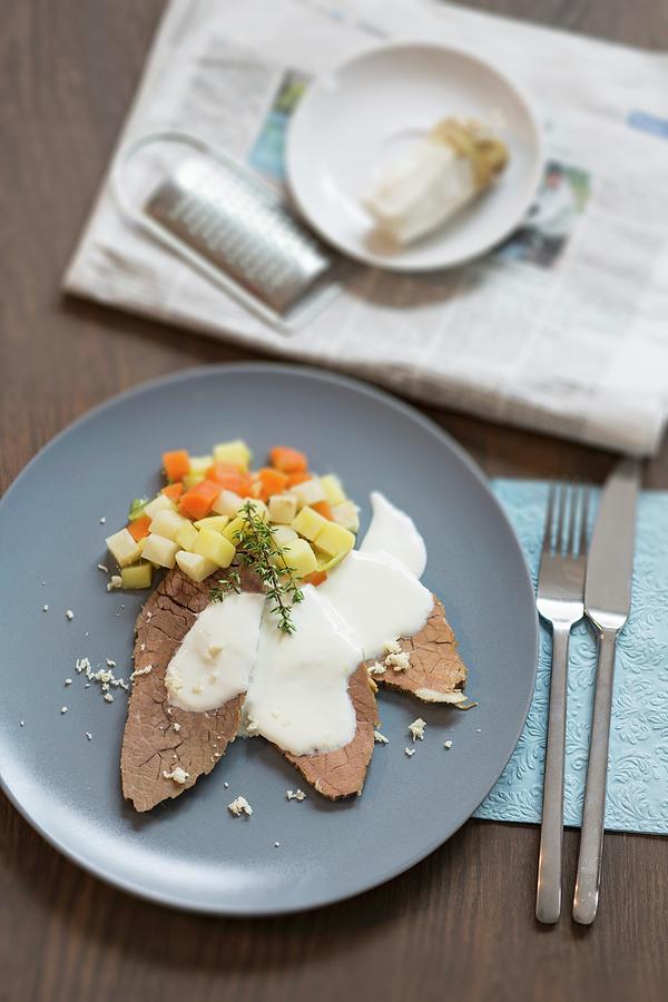 Prime Boiled Beef With A Horseradish Sauce And Bouillon Potatoes Accompanied By Fresh Horseradish And The Daily Newspaper Photograph by Jan Wischnewski