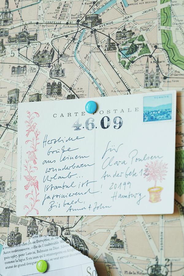 Printed And Hand-written Postcard On Pin Board With Map As Background Photograph by Alexandra Loock