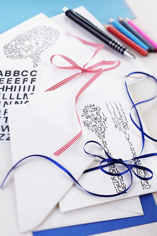 Printed Invitation Cards, Envelopes And Various Ribbons Photograph by Franziska Taube