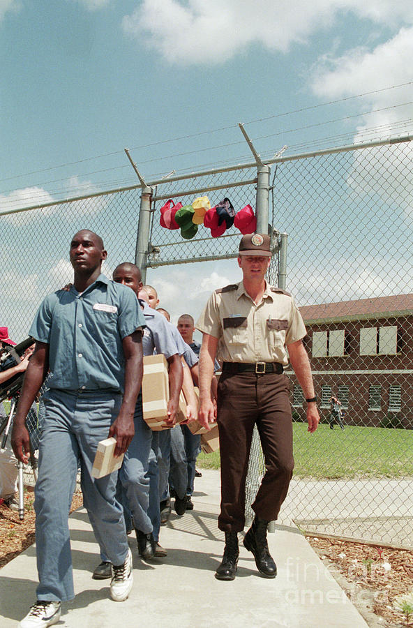 Prison Guard Walking With Inmates Photograph by Bettmann