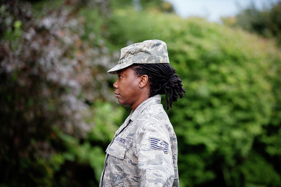 Profile View Of Female Soldier Standing Against Trees Photograph