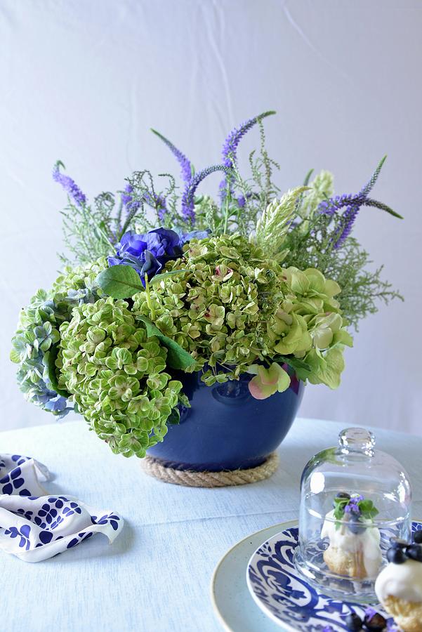 Profiteroles And Flower Arrangement In Blue Vase Photograph by Great Stock!