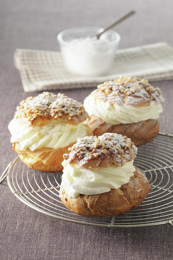 Profiteroles With Cream, Nuts And Icing Sugar Photograph by Jean-christophe Riou