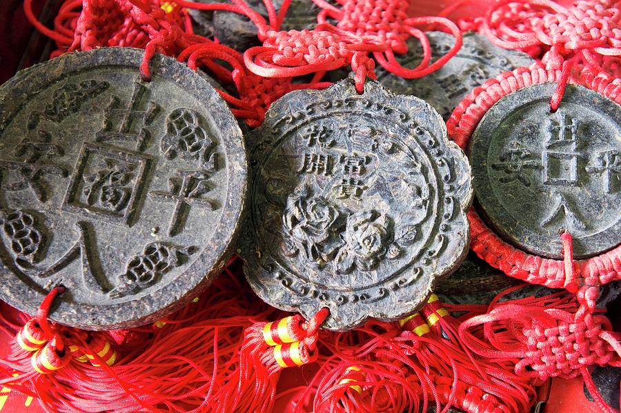 Pu-ehr Tea Cakes Shaped Like Coins With Chinese Writing Photograph by Martina Schindler