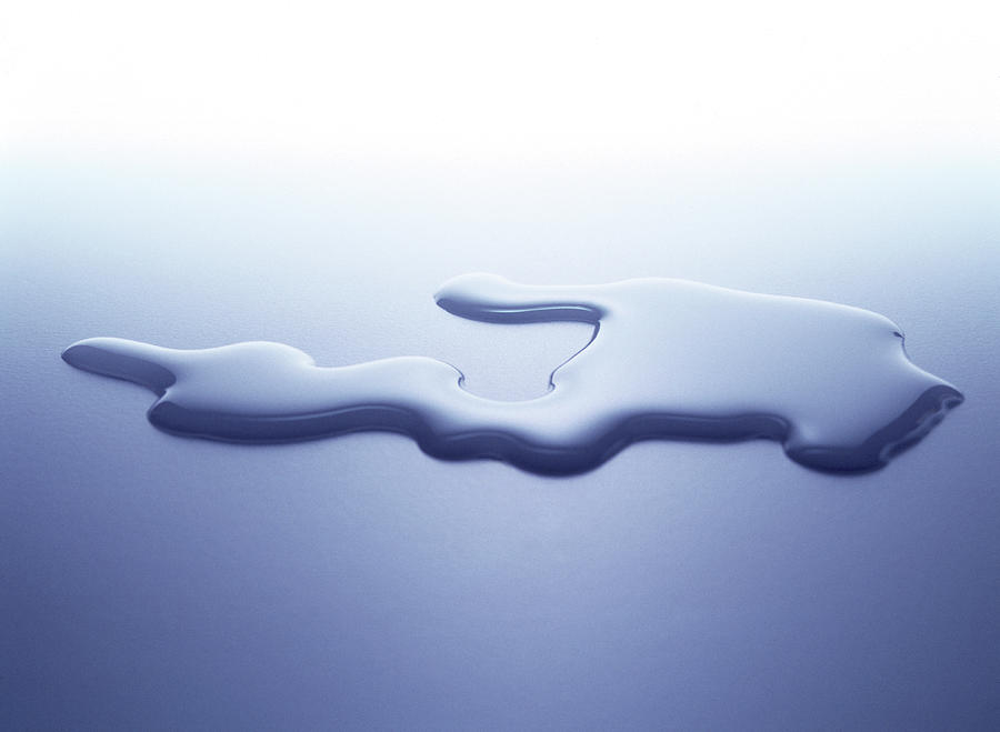 Puddle Of Water On White Surface Photograph by Nicholas Eveleigh