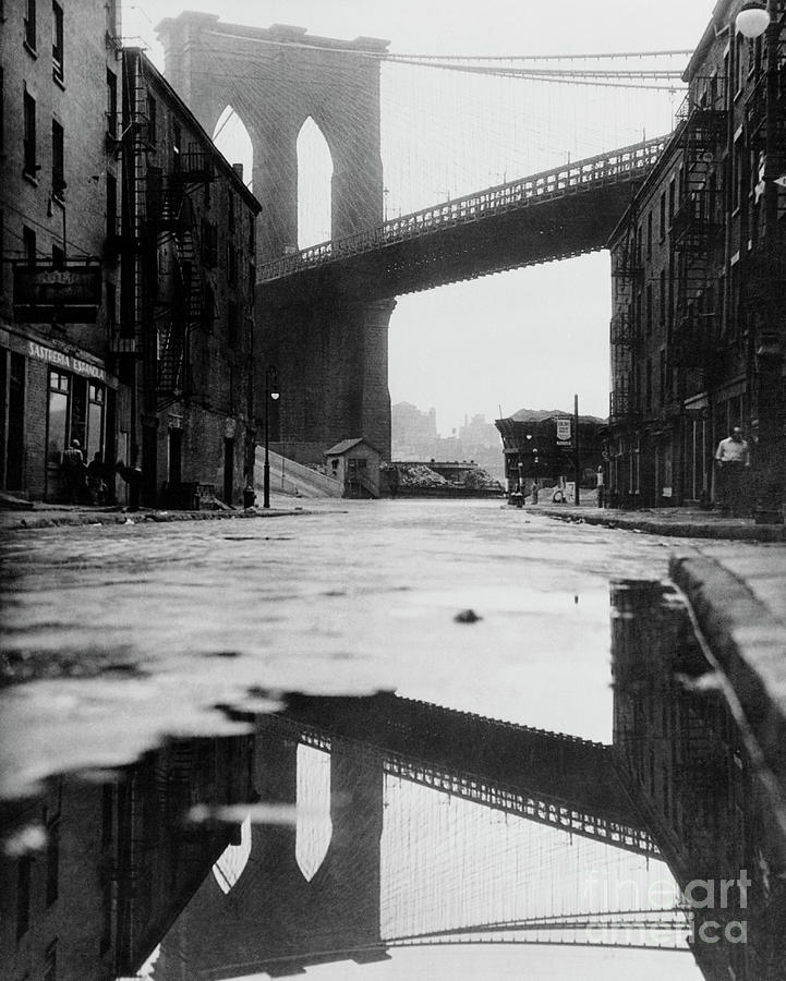 Puddle Reflecting Brooklyn Bridge Photograph by Bettmann