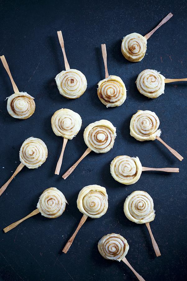 Puff Pastry Cinnamon Snails On Sticks Photograph by Kati Neudert