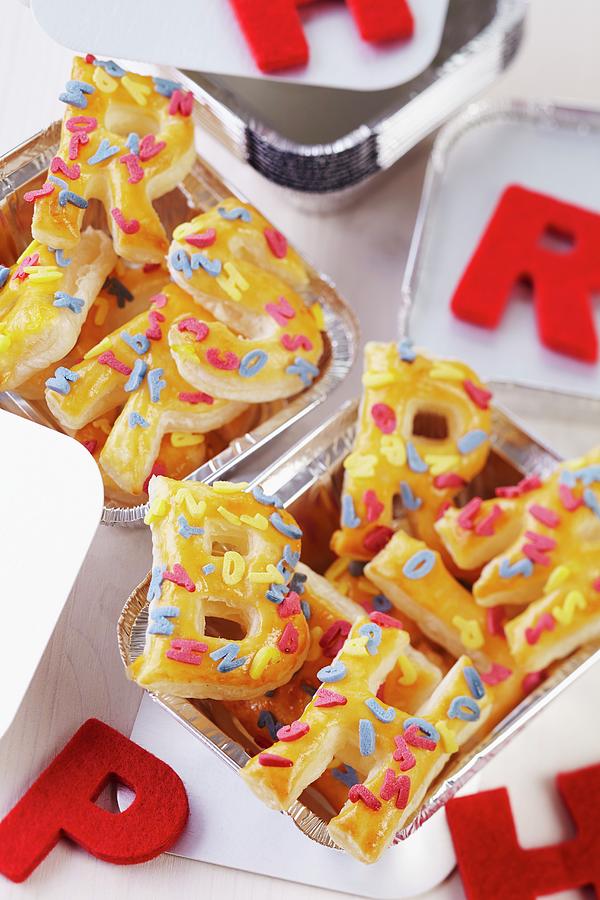 Puff Pastry Letters With Decorations In Aluminium Trays Photograph by Franziska Taube
