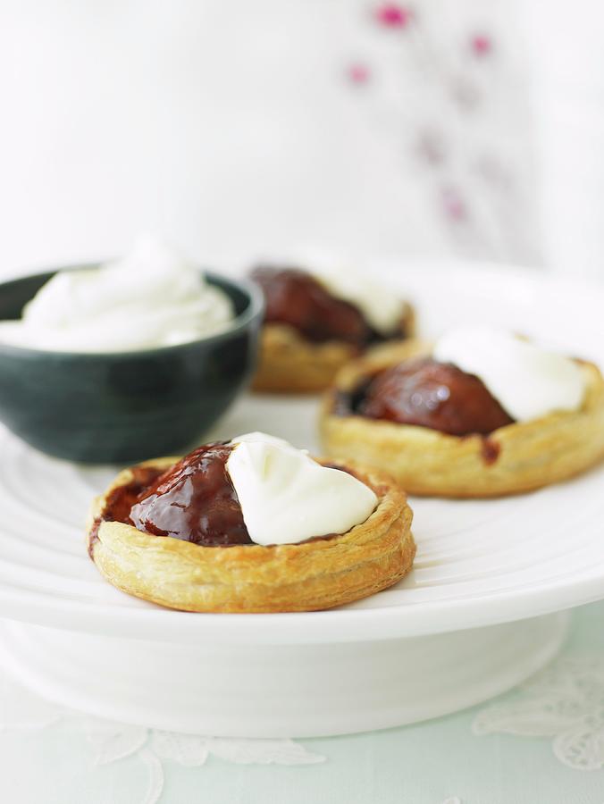 Puff Pastry Pear Tartlets With Chocolate Sauce And Cream Photograph by Myles New