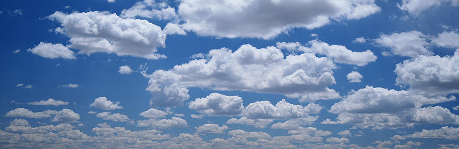 Puffy White Cumulus Clouds In A Bright Photograph by Edward Bottomley