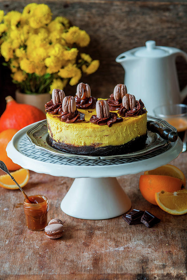 Pumpkin And Orange Cheesecake With A Brownie Base And Macarons Photograph by Irina Meliukh