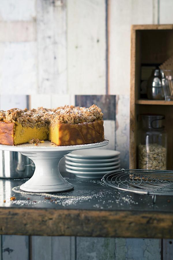 Pumpkin Cheesecake With Apple Crumbles On A Cake Stand Photograph by Jalag / Wolfgang Schardt