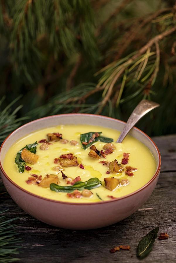 Pumpkin Soup With Bacon And Toasted Chickpeas Photograph by Winfried Heinze