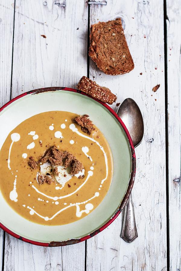 Pumpkin Soup With Cream Served With Wholemeal Bread Photograph by Adel Bekefi