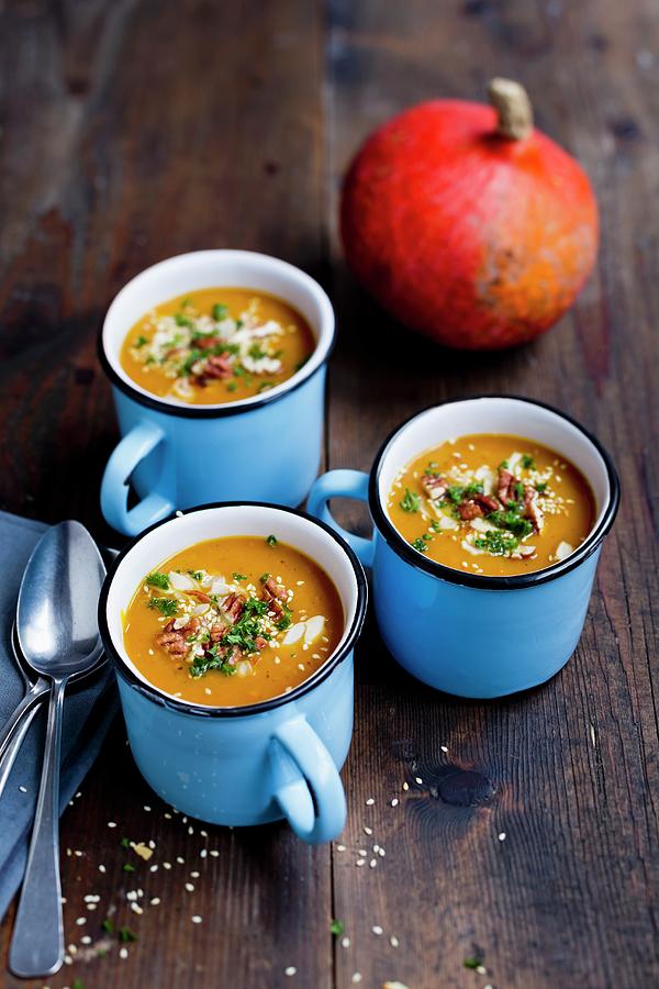 Pumpkin Soup With Pecan Nuts, Sesame Seeds And Almonds Photograph by Sporrer/skowronek