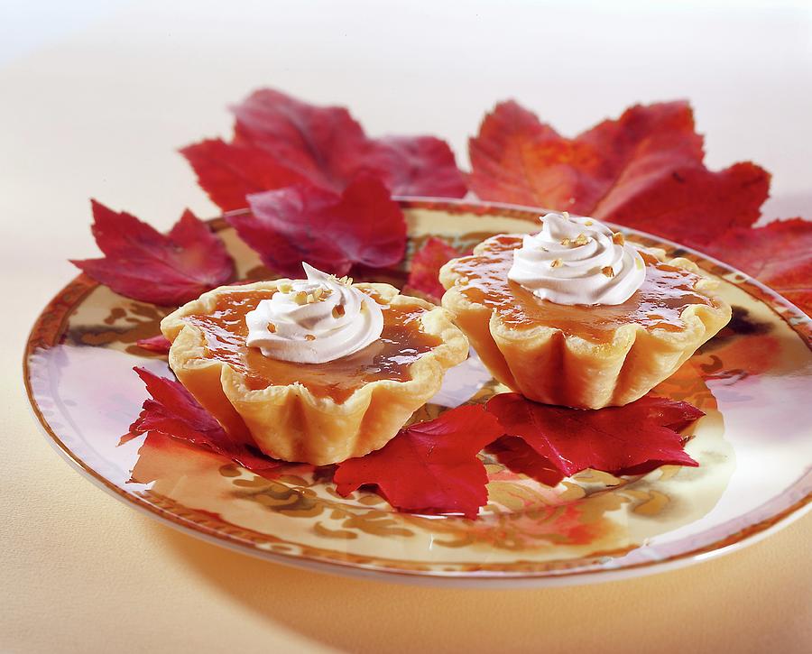 Pumpkin Tartlets On Autumn Leaves Photograph by Colin Cooke