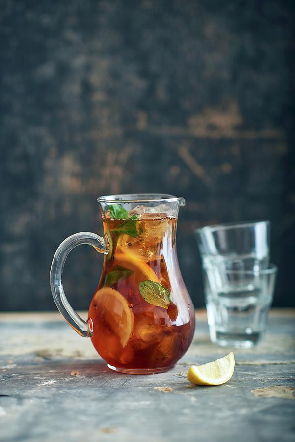 Punch In A Glass Jug On A Wooden Table Photograph by Yehia Asem El Alaily