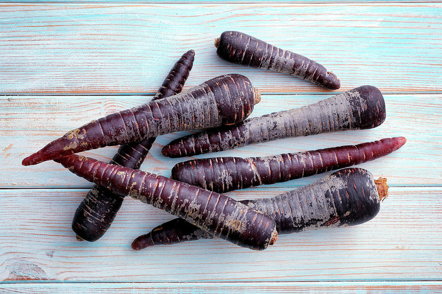 Purple Carrots On A Wooden Background Photograph by Petr Gross
