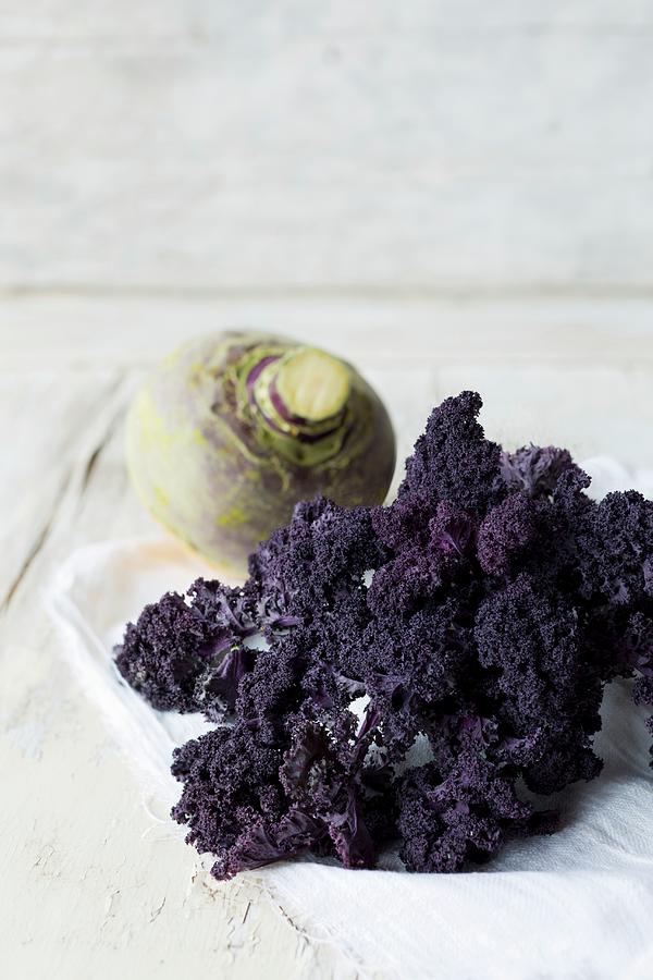 Purple Curly Kale And A Turnip On A Linen Cloth Photograph by Sabine Lscher