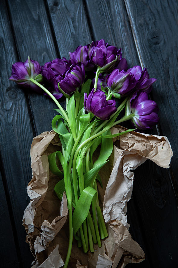 purple Peony Tulips In Brown Paper On Wooden Surface Photograph by Catja Vedder