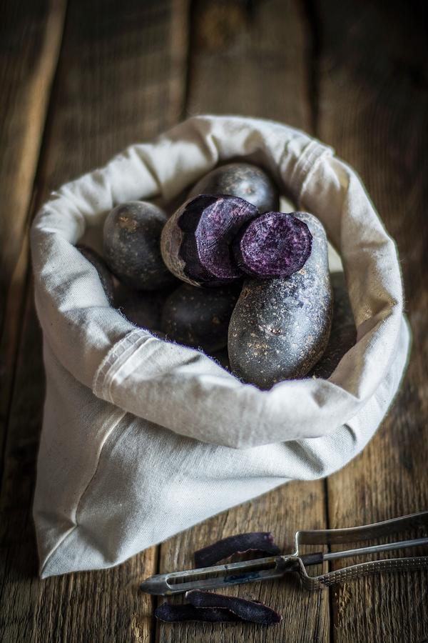 Purple Potatoes In A Fabric Bag Photograph by Adriana Baran