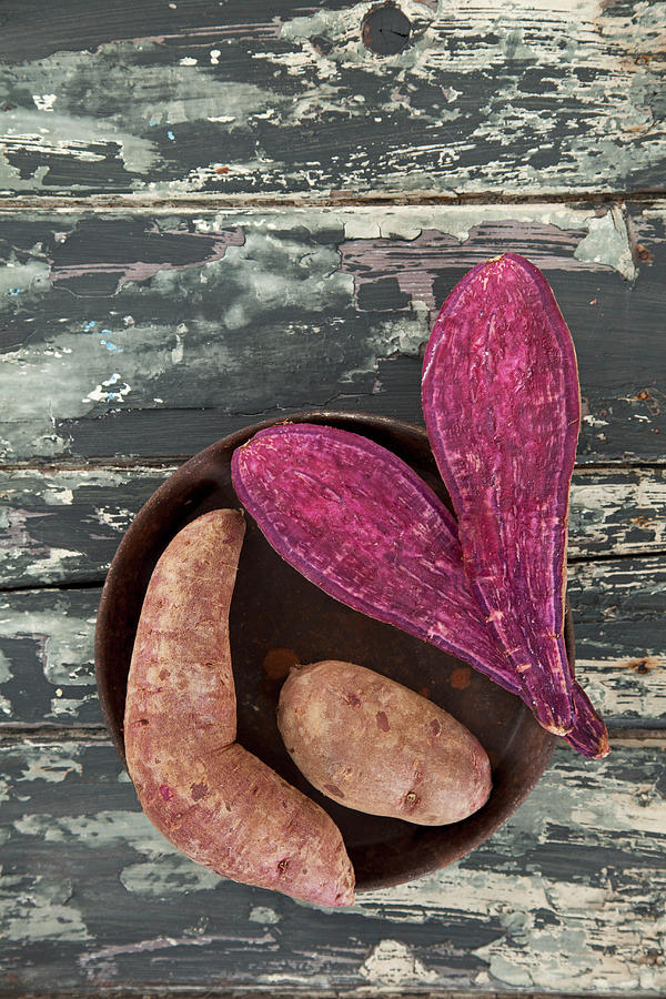Purple Sweet Potatoes, Whole And Halved Photograph by Ulrike Kirmse