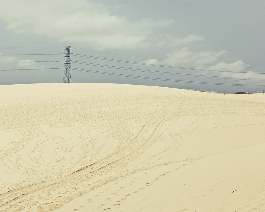 Pylon Atop Sand Dune Photograph by Photograph By Chris Round