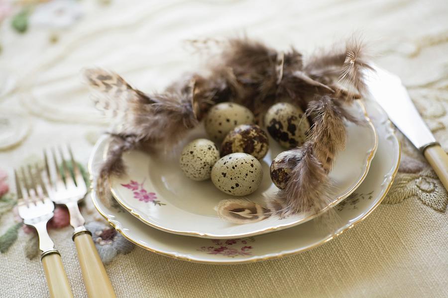 Quail Eggs And Feathers On Floral Gold-rimmed Plate And Vintage Cutlery Photograph by Alicja Koll