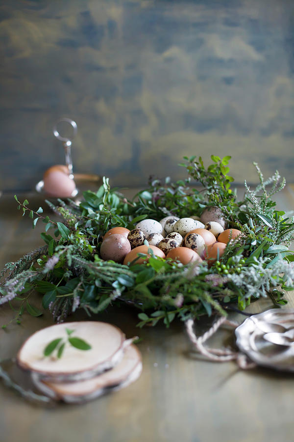 Quail Eggs And Hens Eggs In Easter Wreath Photograph by Alicja Koll