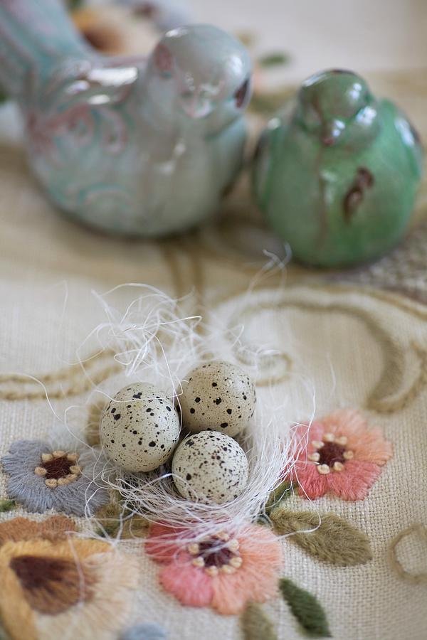 Quail Eggs On White Ornamental Straw And Turquoise Bird Ornaments On Embroidered Vintage Tablecloth Photograph by Alicja Koll