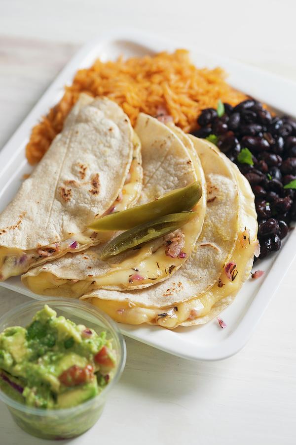 Quesadillas Filled With Cheese Served With Black Beans, Tomato Rice And Guacamole Photograph by Laurange