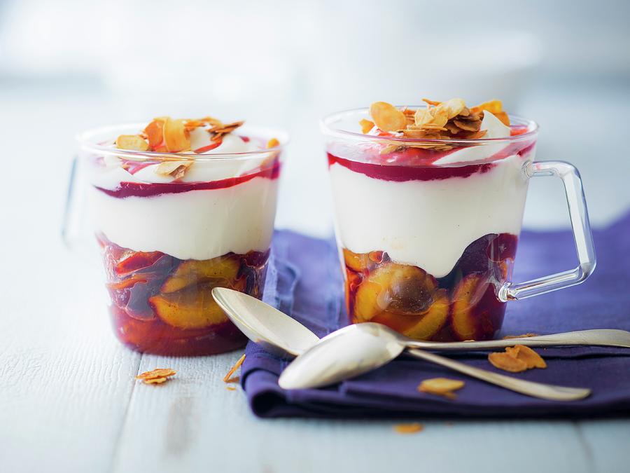 Quetsch Plums In Syrup, Cream, Redcurrant Coulis And Caramelized Thinly Sliced Almond Dessert Photograph by Roulier-turiot